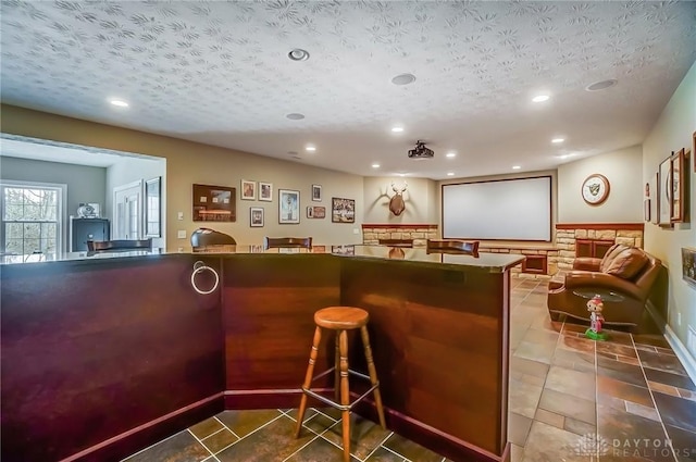 bar featuring a textured ceiling, tile patterned floors, and recessed lighting