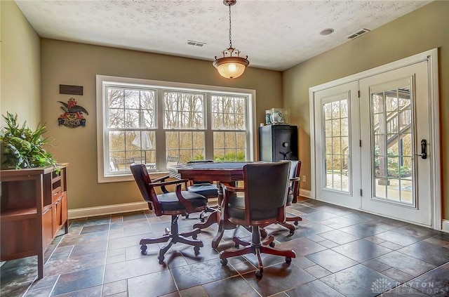 dining room featuring visible vents, plenty of natural light, and baseboards