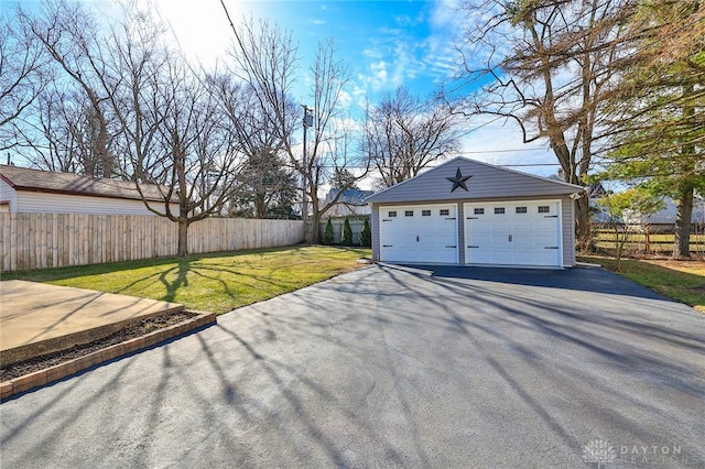 detached garage featuring fence