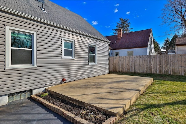 wooden deck featuring a patio, a lawn, and fence