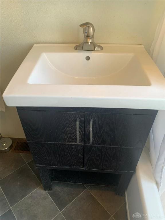 bathroom featuring tile patterned flooring and vanity