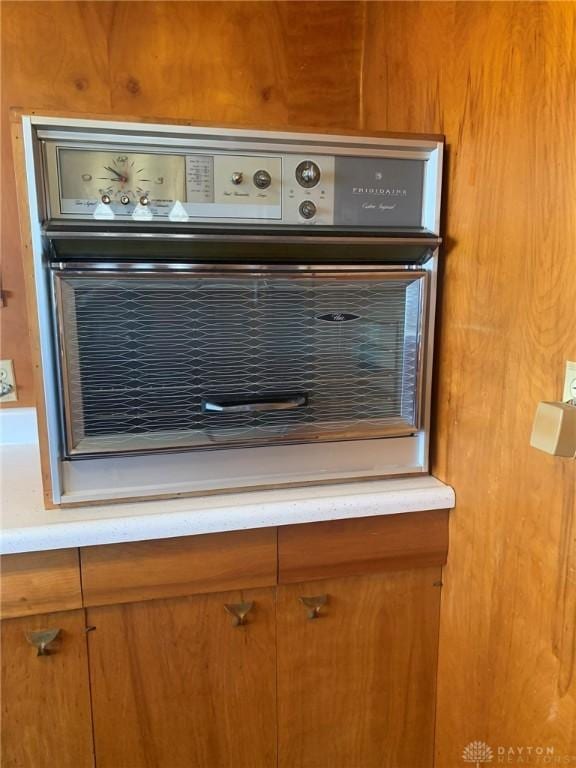 details featuring brown cabinets and light countertops