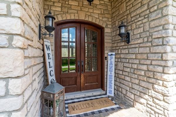 view of exterior entry featuring french doors