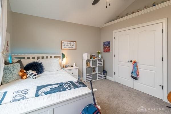 bedroom featuring lofted ceiling, carpet, a closet, and ceiling fan