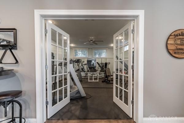 gym featuring french doors and a ceiling fan