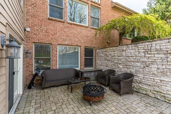 view of patio / terrace featuring an outdoor fire pit