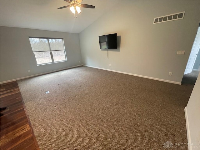 unfurnished living room with visible vents, baseboards, and vaulted ceiling