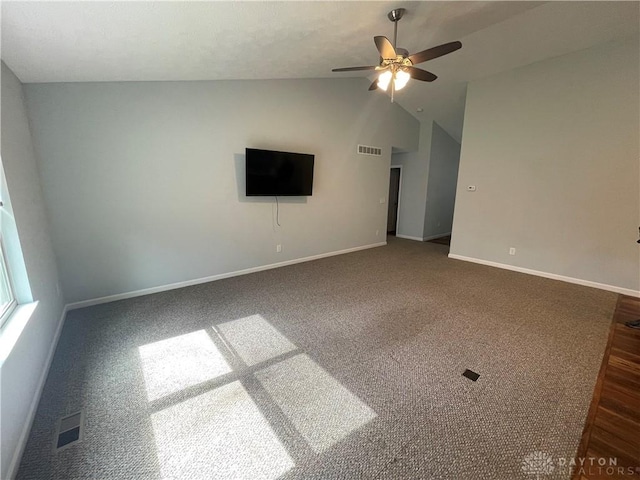 empty room featuring visible vents, baseboards, lofted ceiling, and a ceiling fan