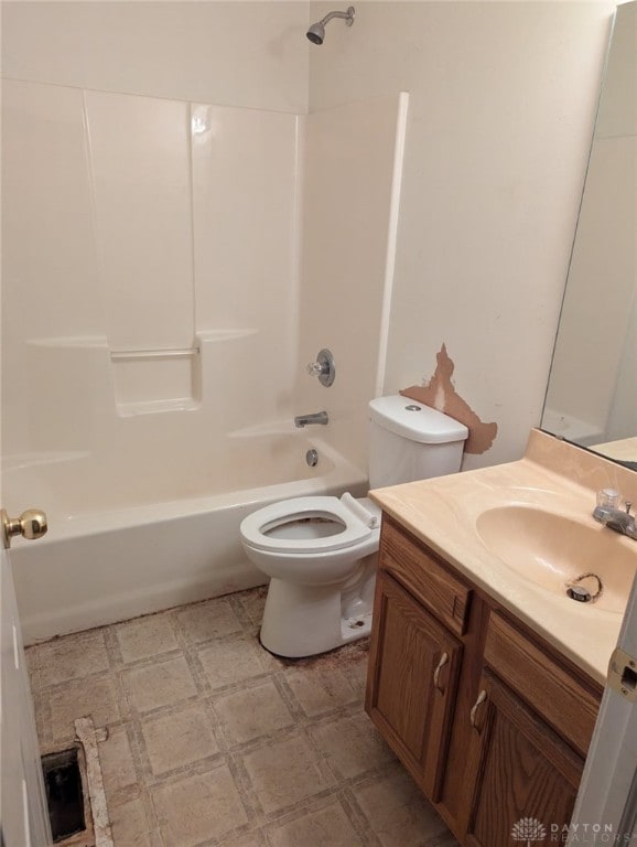 bathroom featuring tile patterned floors, tub / shower combination, toilet, and vanity