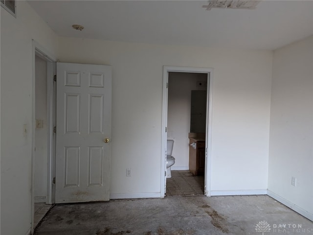 unfurnished bedroom with unfinished concrete floors, baseboards, visible vents, and connected bathroom