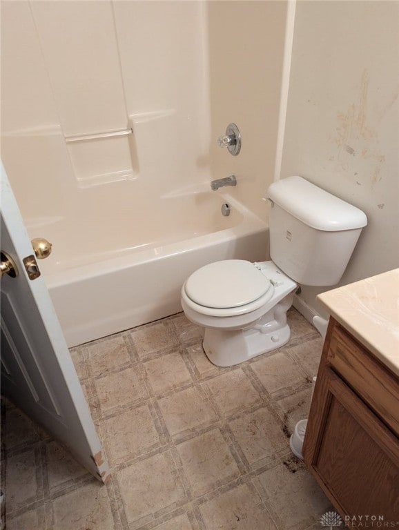 full bathroom with vanity, tile patterned floors, toilet, and shower / washtub combination