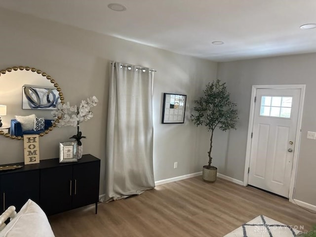 foyer featuring light wood-style floors and baseboards