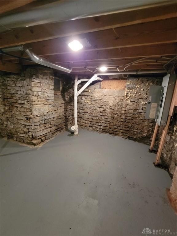 unfinished basement featuring electric panel