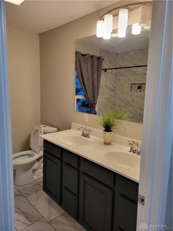 bathroom with a sink, toilet, marble finish floor, and double vanity