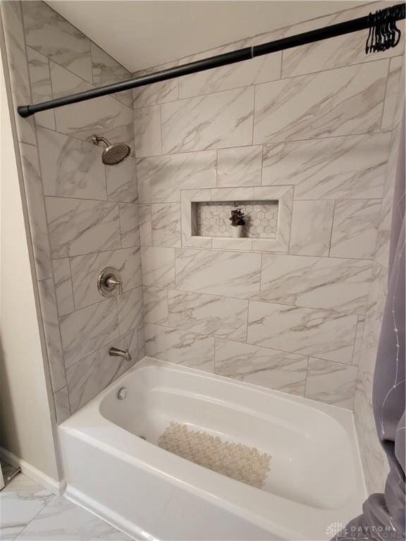 full bathroom featuring baseboards, marble finish floor, and shower / washtub combination