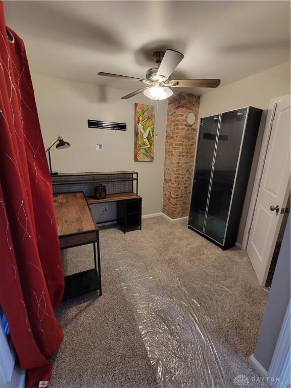 bedroom with baseboards, a ceiling fan, and freestanding refrigerator