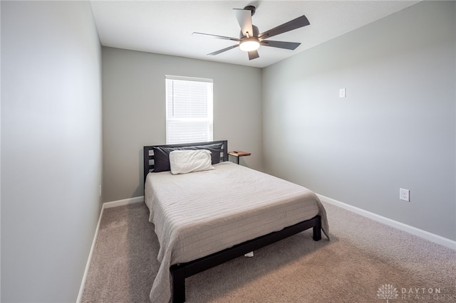 bedroom featuring baseboards, carpet floors, and a ceiling fan