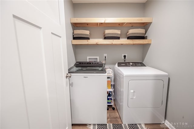 washroom featuring washer and clothes dryer and laundry area