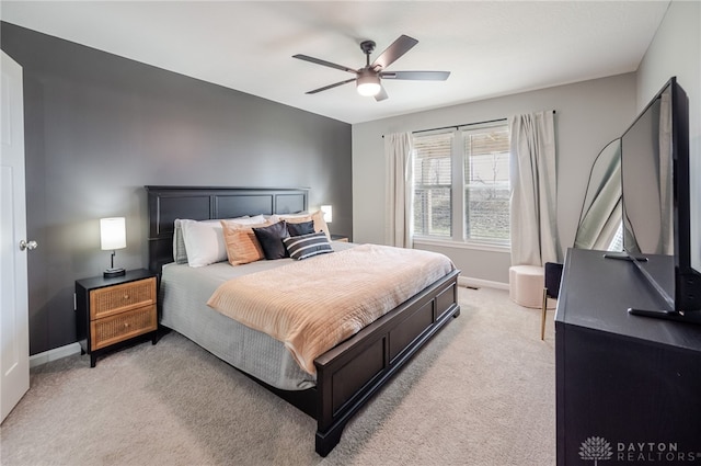 bedroom with baseboards, light colored carpet, and ceiling fan