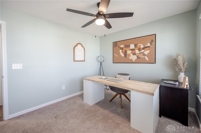 office space featuring carpet, baseboards, and ceiling fan