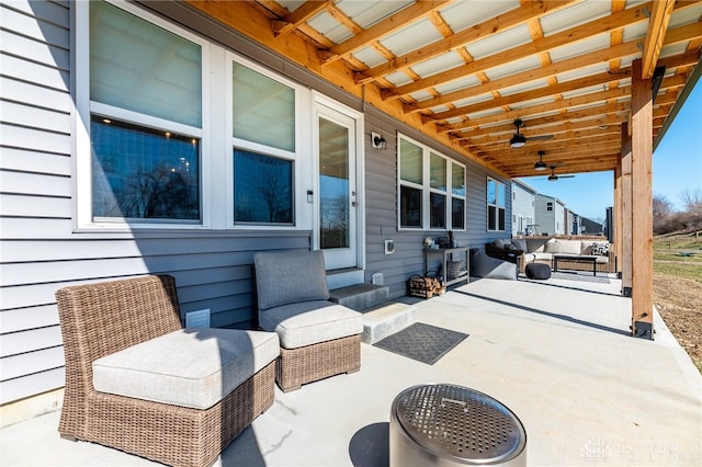 view of patio with an outdoor living space and a ceiling fan