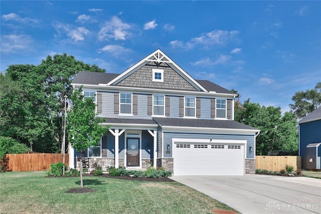 craftsman-style house featuring concrete driveway, a garage, fence, and stone siding