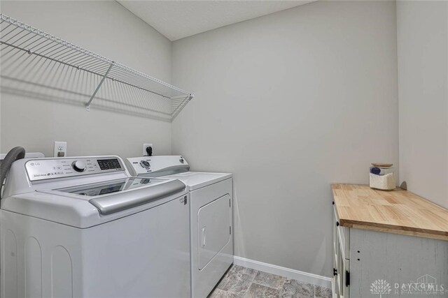 laundry area featuring baseboards, laundry area, and washing machine and clothes dryer