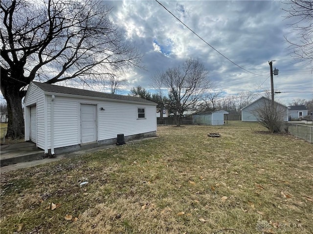 view of yard featuring an outdoor structure and fence