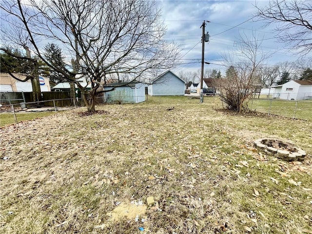 view of yard featuring a fire pit and fence