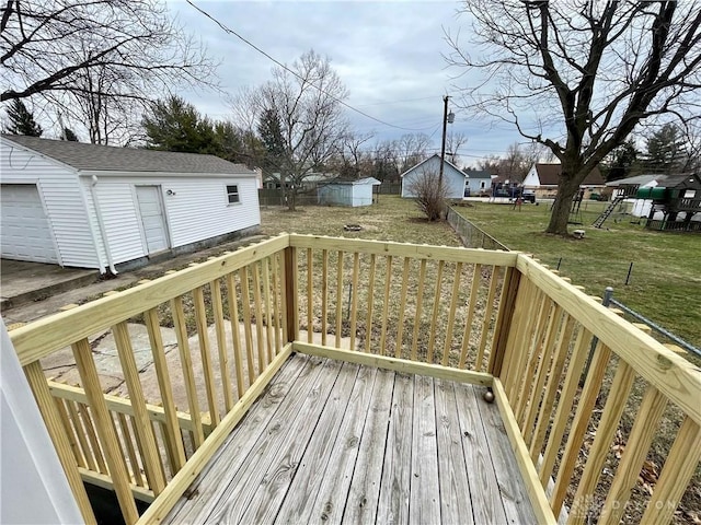 wooden deck featuring a yard, fence private yard, and an outdoor structure