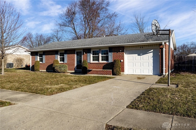 ranch-style home with driveway, fence, a front yard, an attached garage, and brick siding