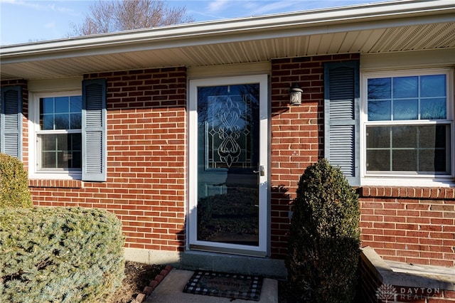 property entrance featuring brick siding