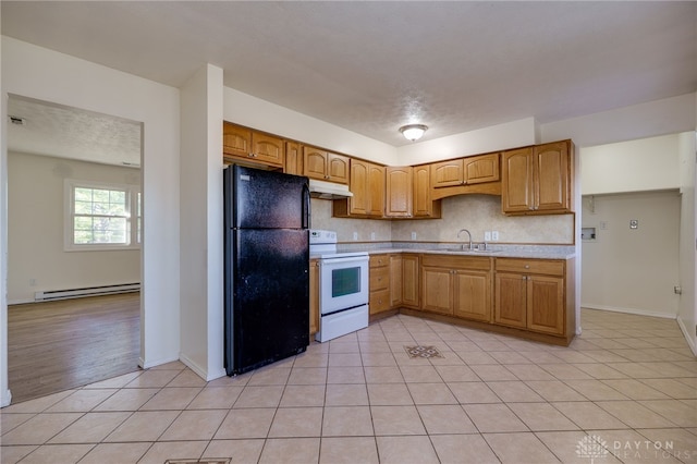 kitchen featuring white range with electric cooktop, a sink, freestanding refrigerator, light countertops, and baseboard heating