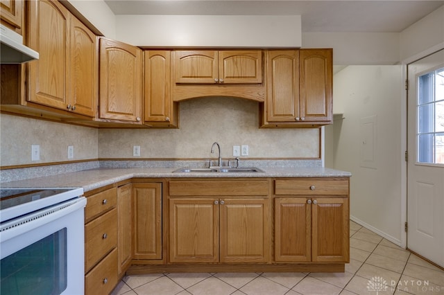 kitchen with electric range, light tile patterned flooring, a sink, light countertops, and exhaust hood