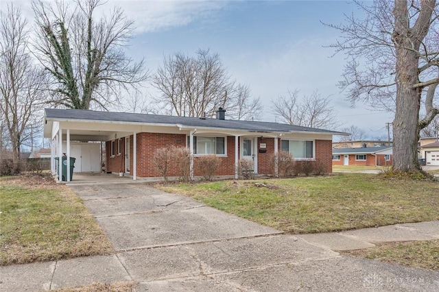 ranch-style house featuring a carport, brick siding, concrete driveway, and a front lawn