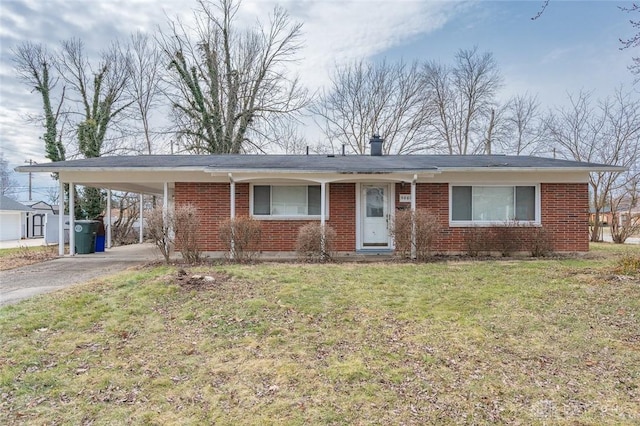 single story home featuring brick siding, driveway, a front yard, and a carport