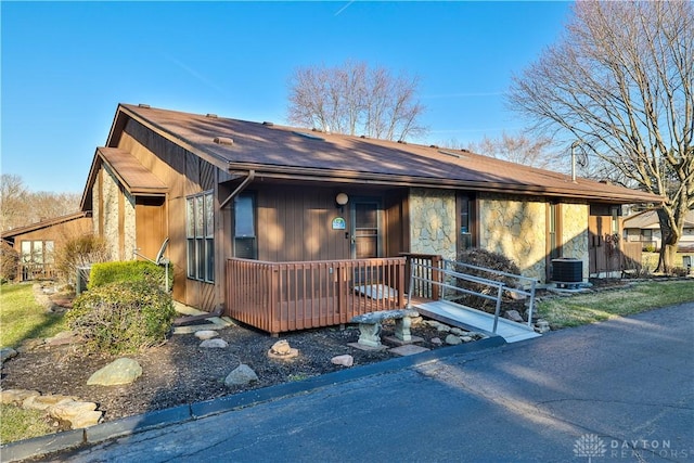 view of front of home featuring covered porch and stone siding