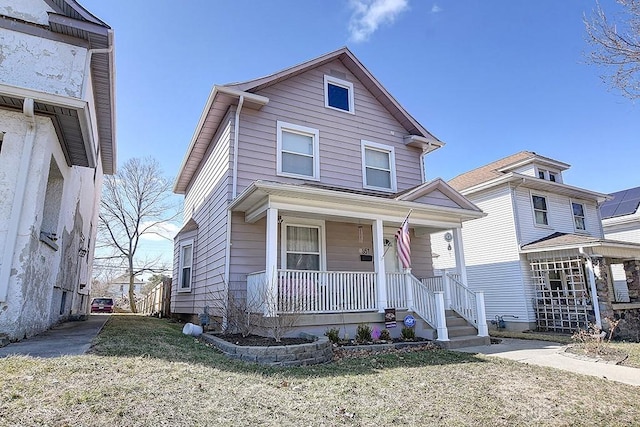 view of front facade with covered porch and a front yard