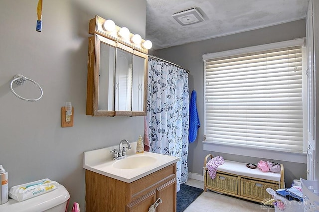 bathroom featuring vanity, curtained shower, toilet, and visible vents