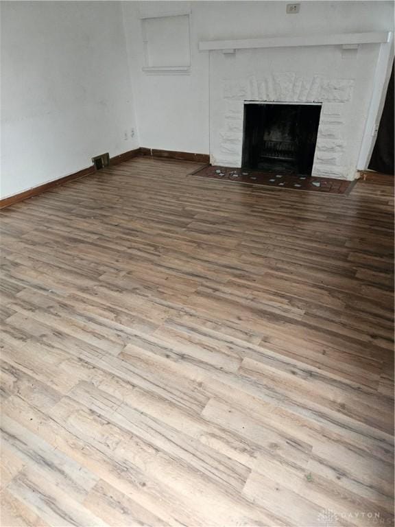 25 Redwood Ave, Dayton, OH 45405 - interior details featuring baseboards, a fireplace with flush hearth, wood finished floors, and visible vents