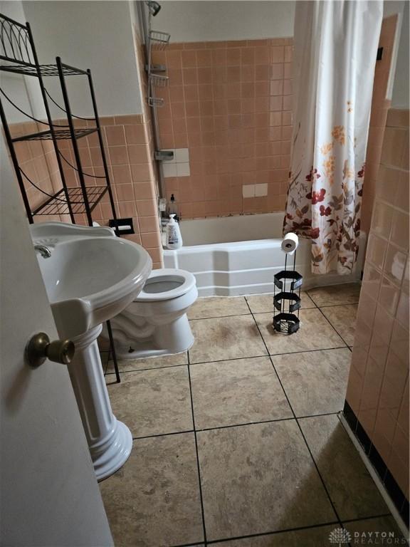 25 Redwood Ave, Dayton, OH 45405 - full bathroom with tile walls, tile patterned flooring, and shower / bath combo