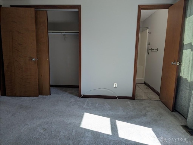 unfurnished bedroom with a closet and carpet