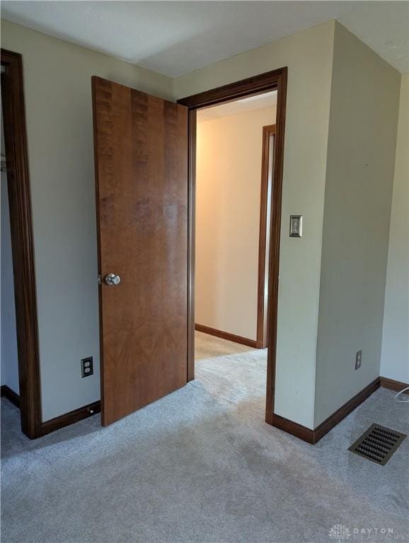 interior space with visible vents, baseboards, and carpet