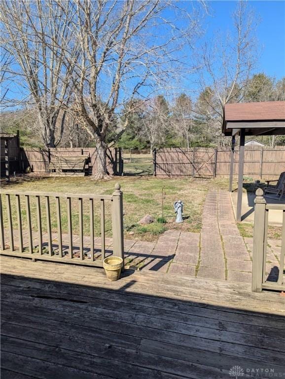 view of yard with a patio area, a deck, and a fenced backyard