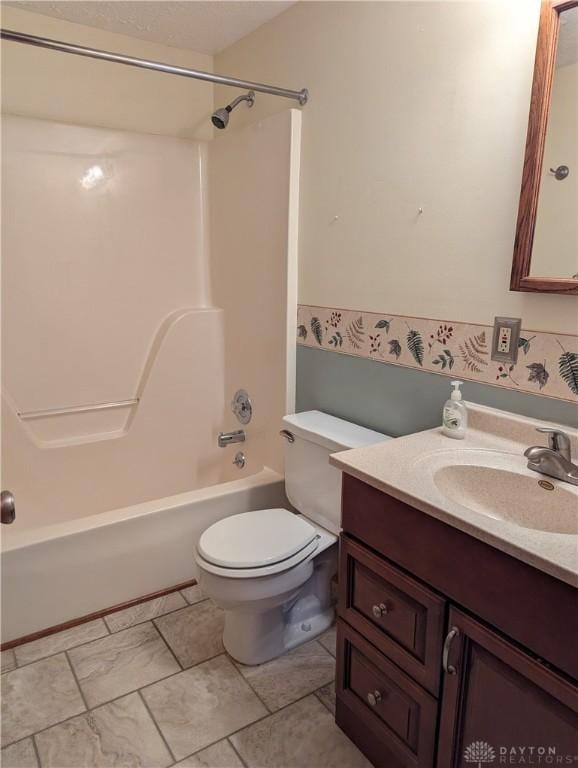 bathroom with vanity, shower / bathtub combination, and toilet