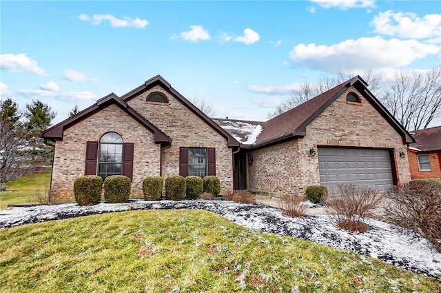 view of front of house featuring brick siding, an attached garage, and a front lawn