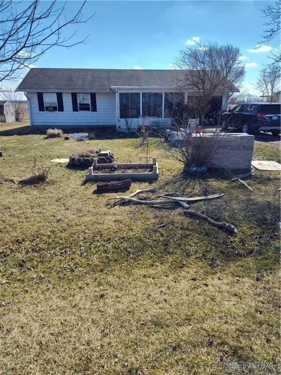 single story home with a front lawn and a sunroom