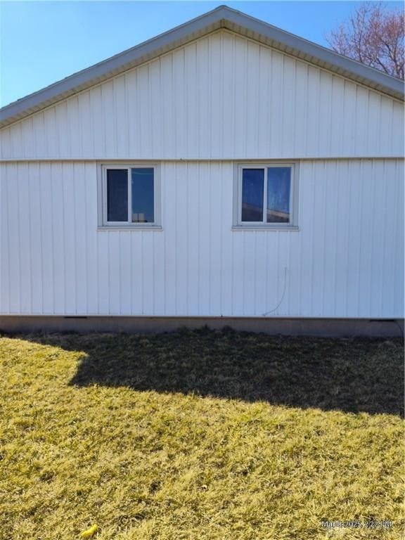 view of side of home with a lawn