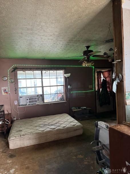 bedroom with cooling unit, concrete flooring, and a textured ceiling