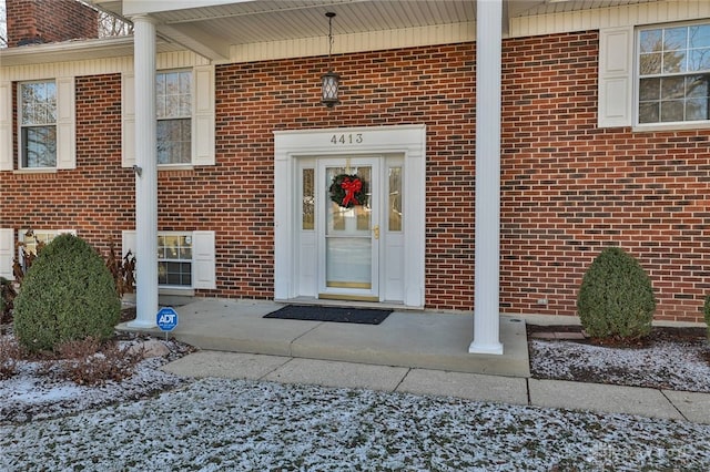 doorway to property with brick siding